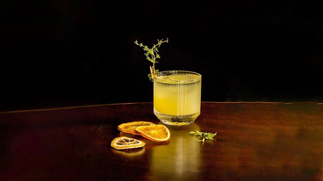 Cocktail with garnish and dried citrus slices at CÉ LA VI Dubai.