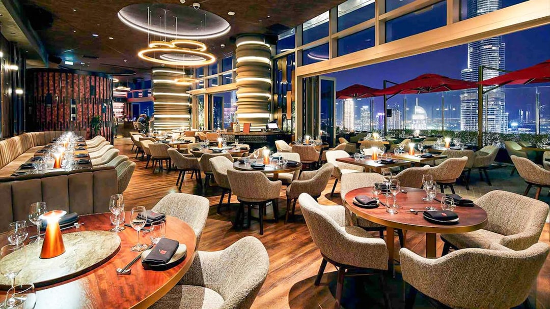 Luxurious dining area at CLV restaurant with city skyline view.
