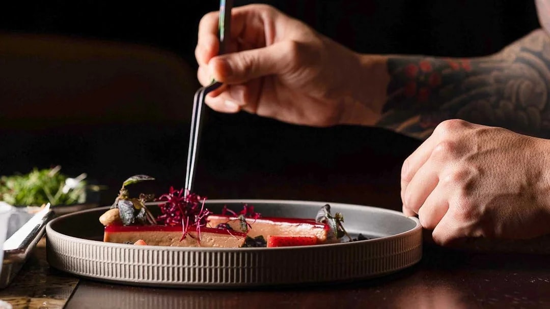 Dining experience at CÉ LA VI Dubai with gourmet dish preparation.