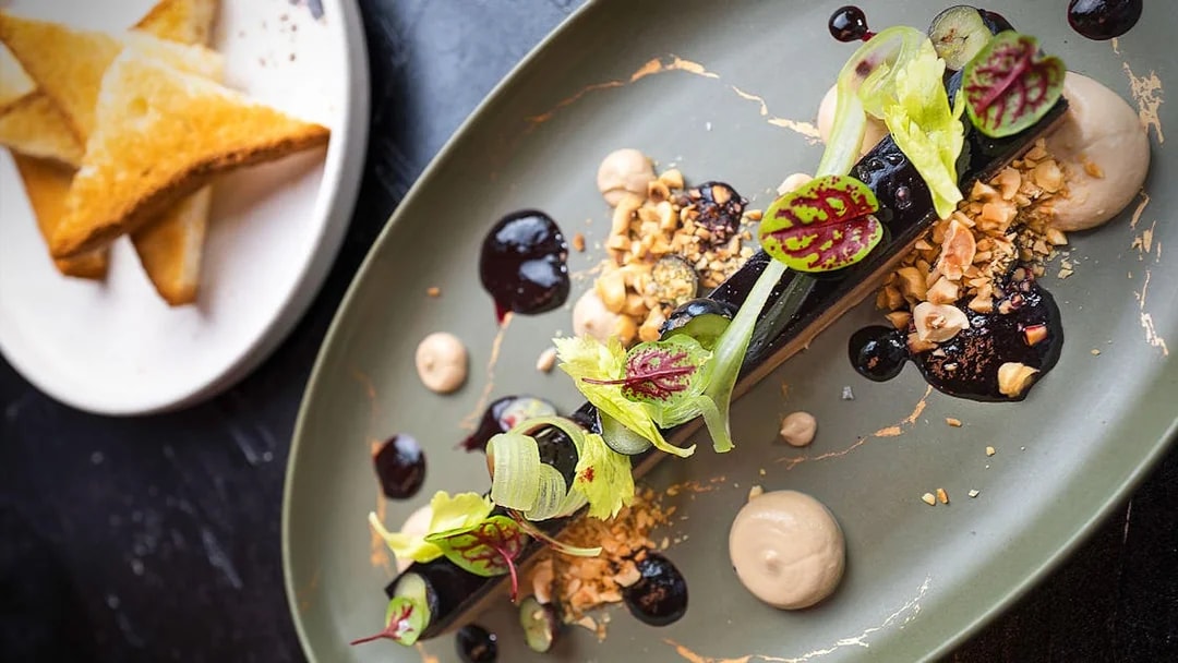 Lunch set menu dish with garnish at CÉ LA VI Dubai, featuring Burj Khalifa views.