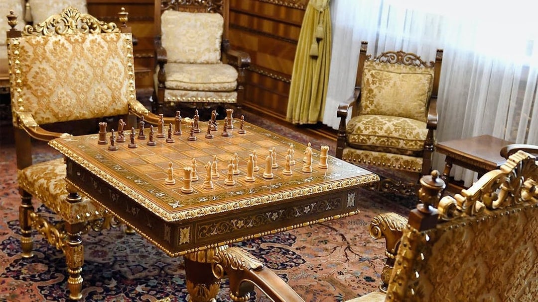 Chess set on ornate table in Ceausescu Mansion's opulent room, part of Fast Track Guided Tour.