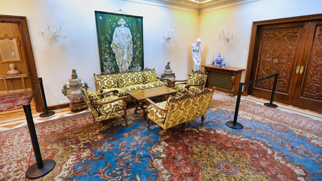 Elegant sitting room in Ceausescu Mansion with ornate furniture and artwork.