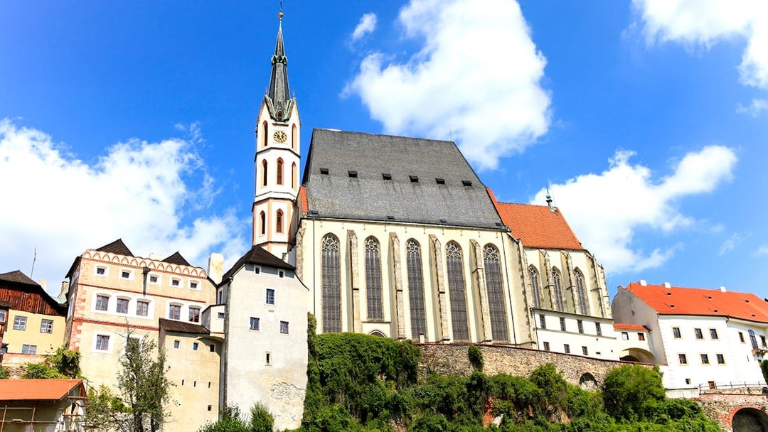 Saint Vitus church exterior with clock tower in Cesky Krumlov, Czech Republic.
