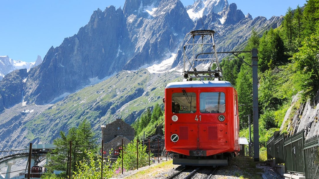 Red train on Mer de Glace route with Mont Blanc in background, Chamonix day trip.