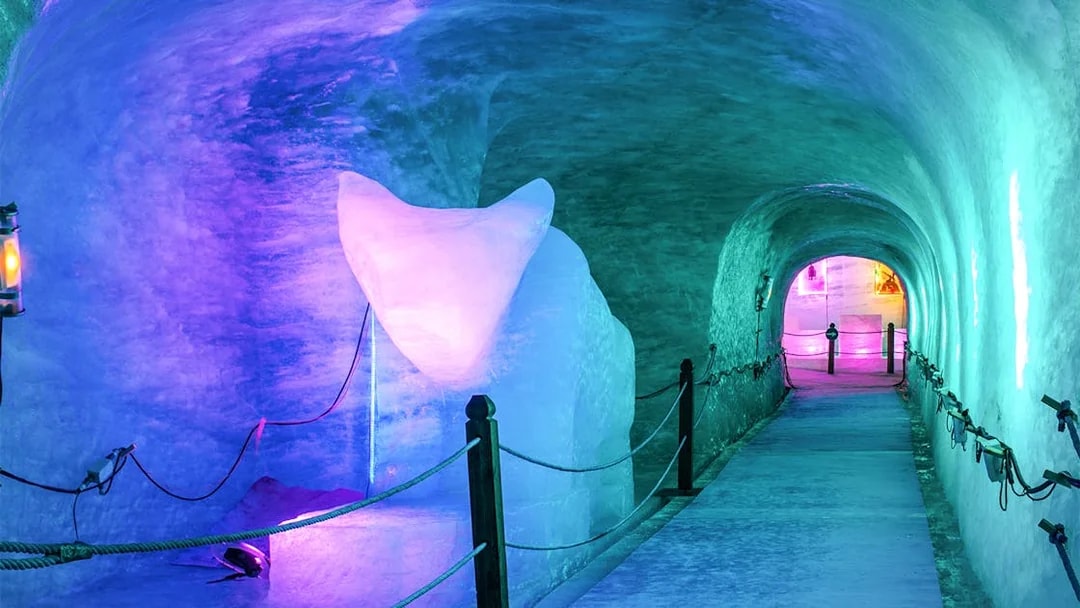 Ice tunnel illuminated with colorful lights on the Mer de Glace train ride, Chamonix Mont Blanc.