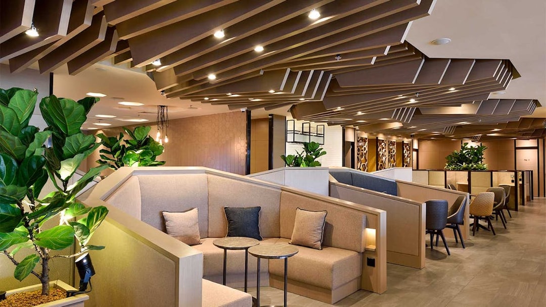 Plaza Premium Lounge seating area with modern decor and plants, T1 International Departures.