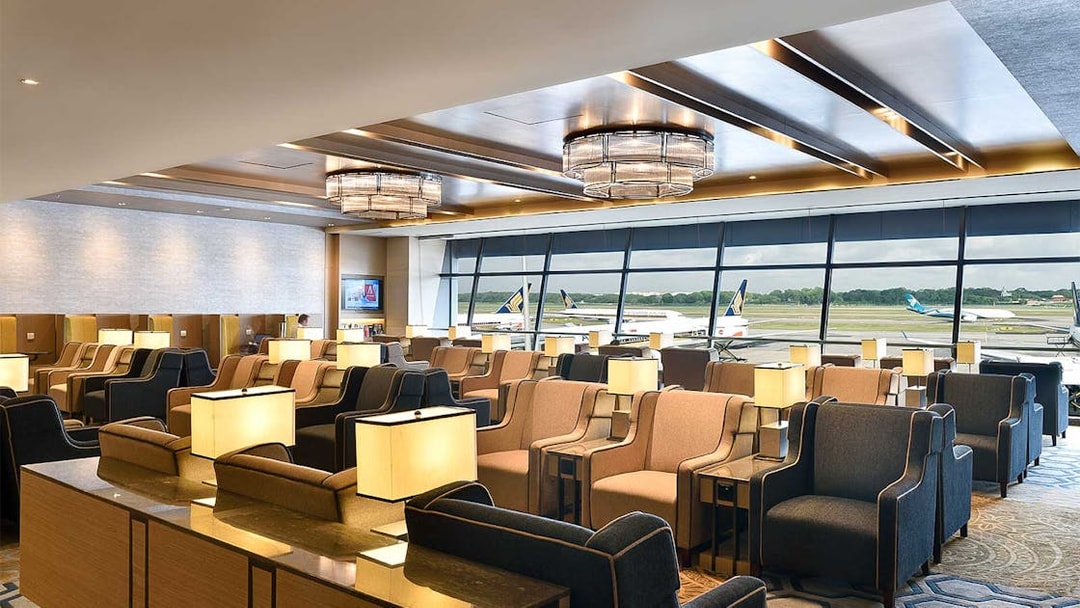 Plaza Premium Lounge seating area with runway view at T1 International Departures.