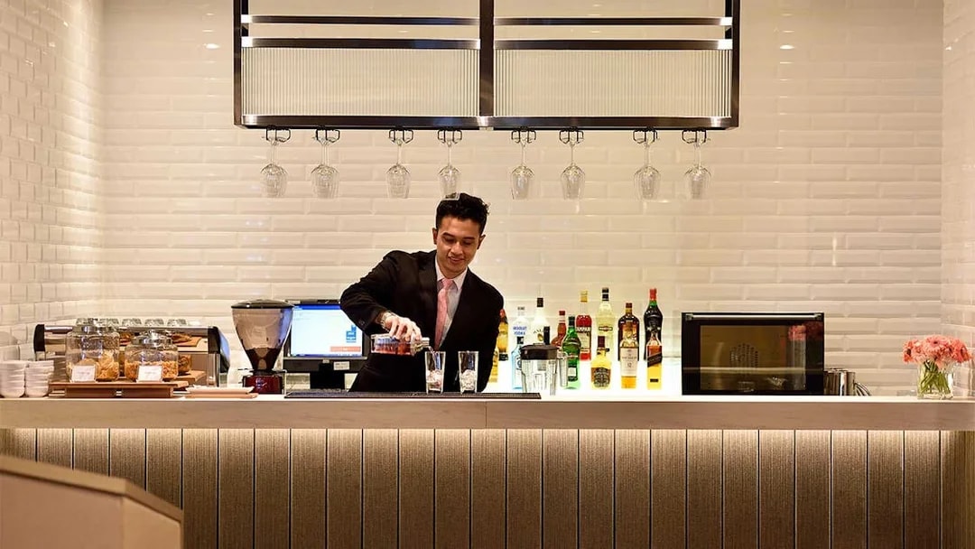 Bartender preparing drinks at Plaza Premium Lounge, T1, International Departures.