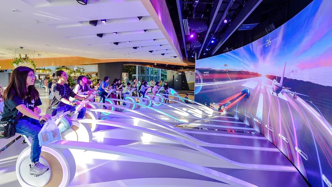 Visitors engaging in interactive experiences at Changi Experience Studio's amazing runway simulation.