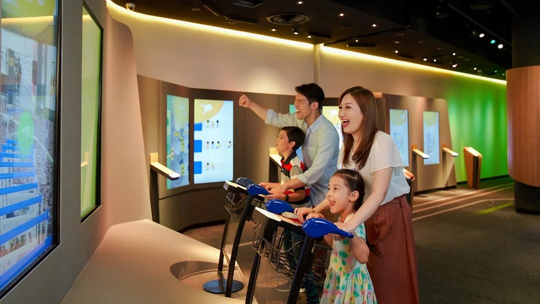 Family enjoying interactive games at Changi Experience Studio, Singapore.