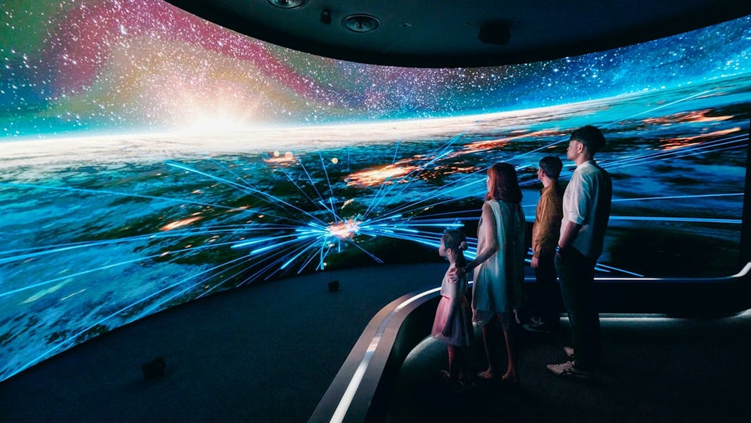 Visitors engaging with digital display at Changi Experience Studio, showcasing interactive experiences.