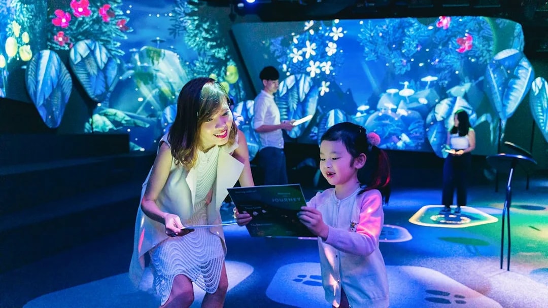 Interactive experience at Garden of Harmony, Changi Experience Studio, with digital displays.