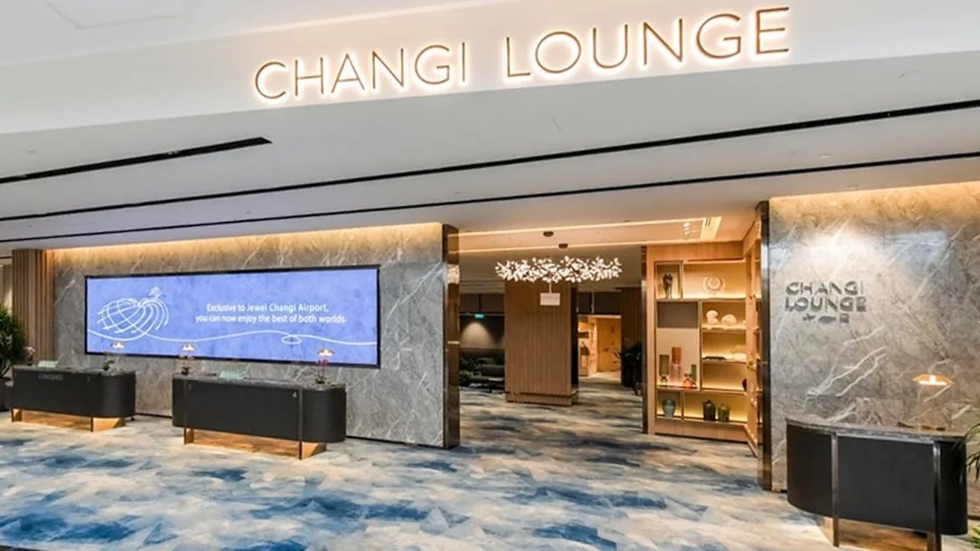 Entrance to Changi Lounge at Singapore Airport with modern decor and reception desks.