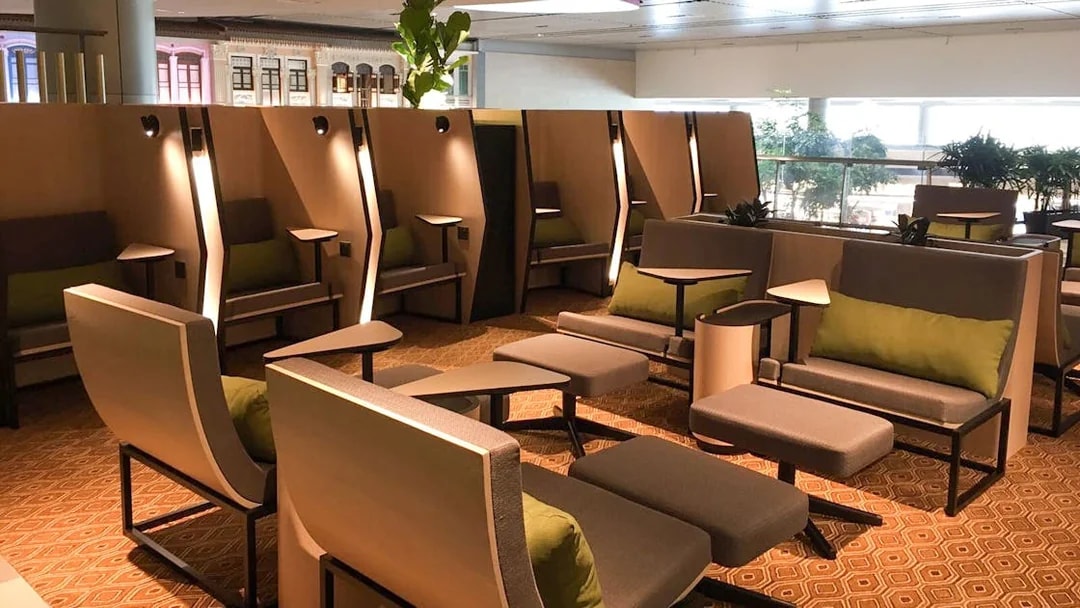 Seating area at Blossom SATS lounge, T4 International Departures, featuring modern chairs and tables.