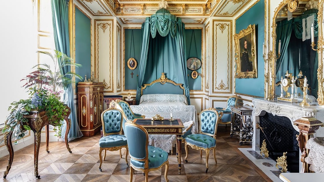 Chateau of Chantilly ornate room with antique furniture and decorative details.