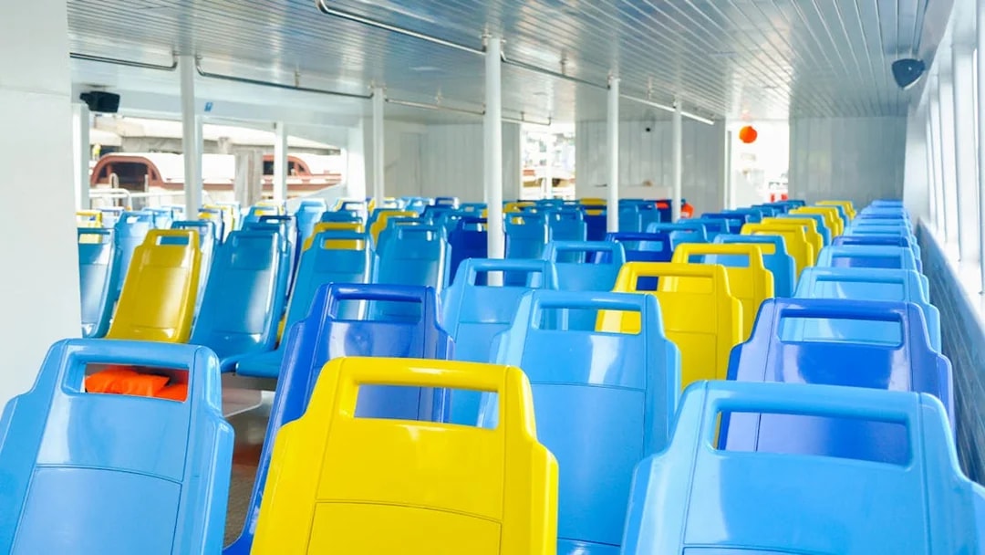 Colorful seats on Chao Phraya Tourist Boat for Bangkok hop-on-hop-off tour.