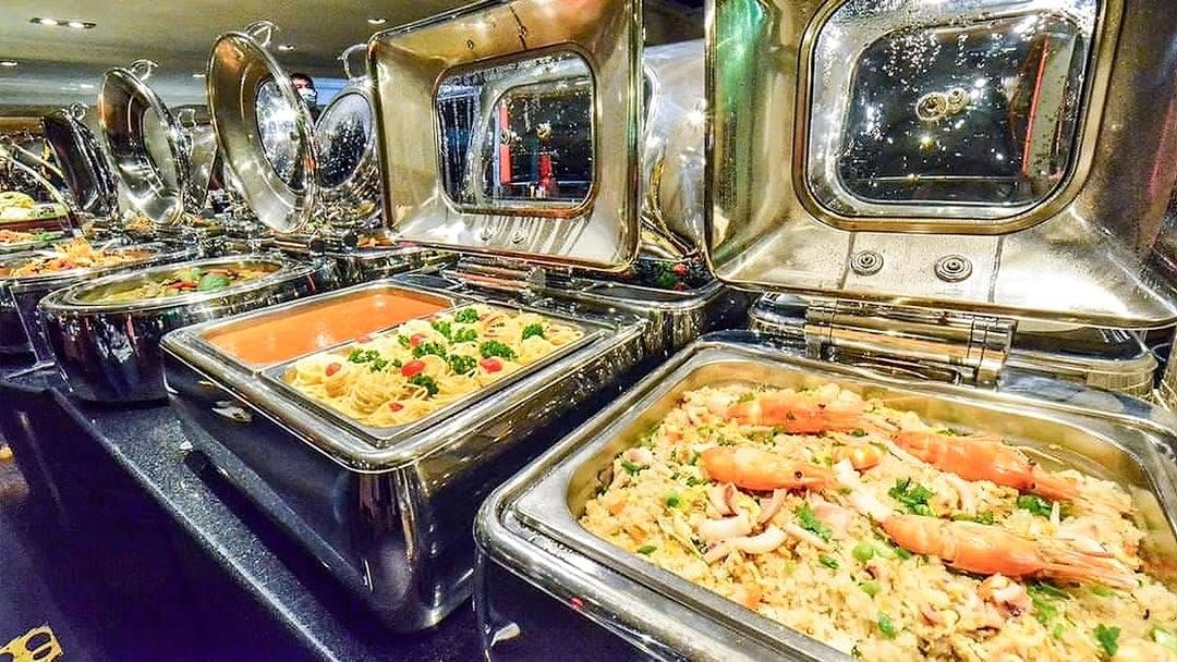 Buffet selection on Chao Phraya Princess dinner cruise with pasta and seafood dishes.