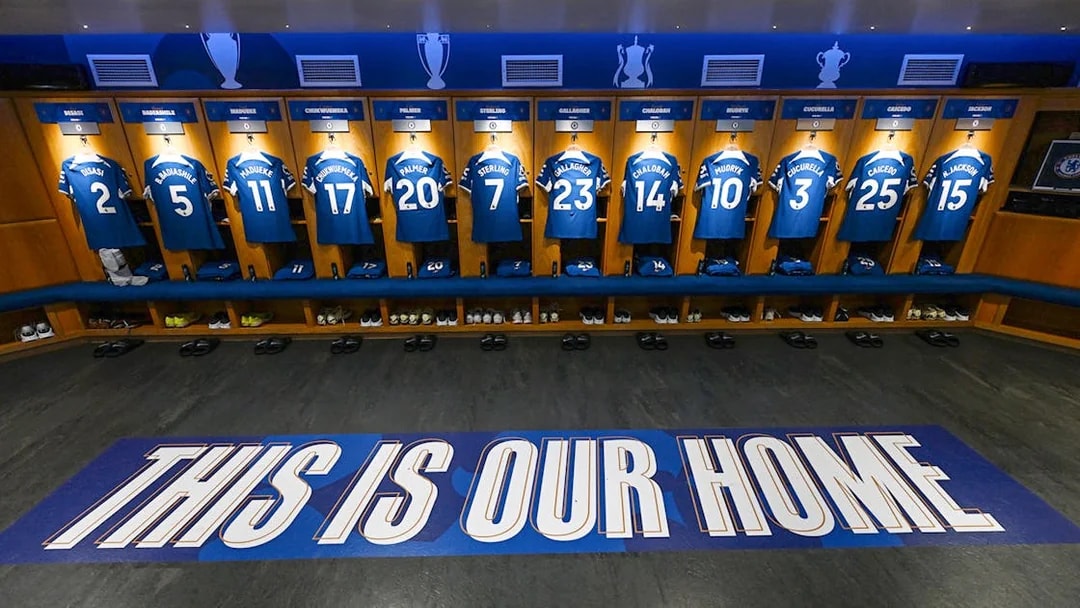 Chelsea FC locker room with player jerseys displayed during stadium tour.