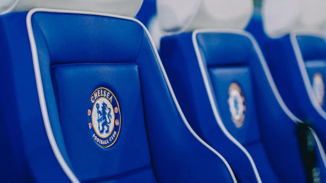 Chelsea FC stadium seats with team logo.