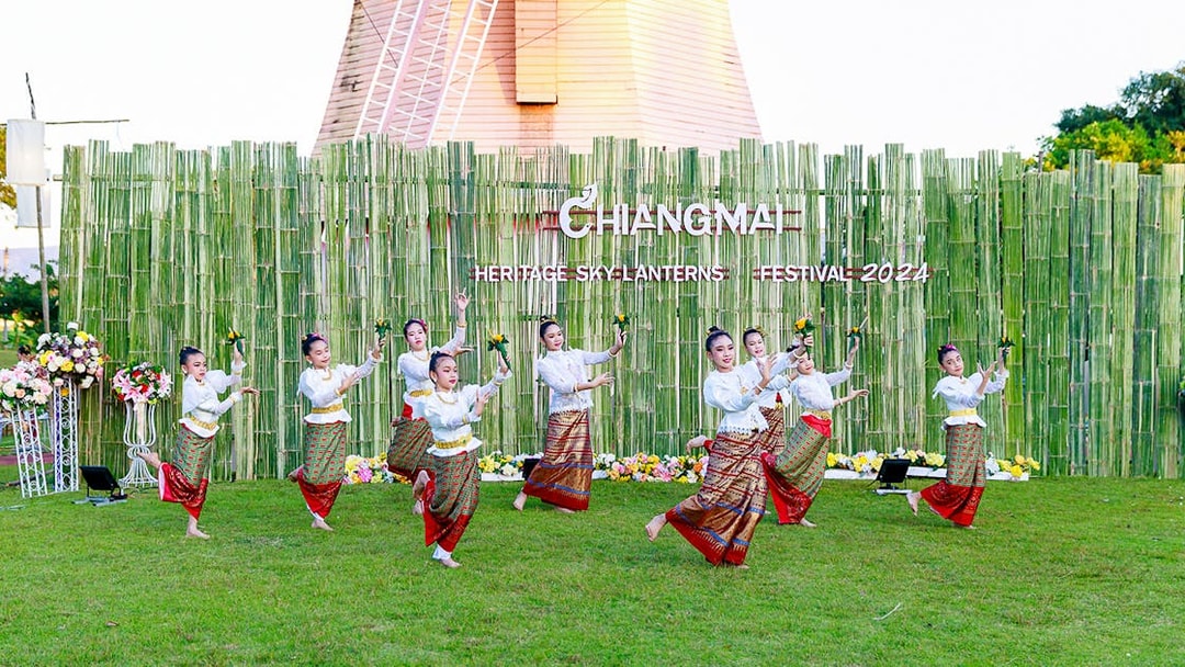 Thai dancers in traditional attire performing at Chiang Mai Sky Lanterns Festival.