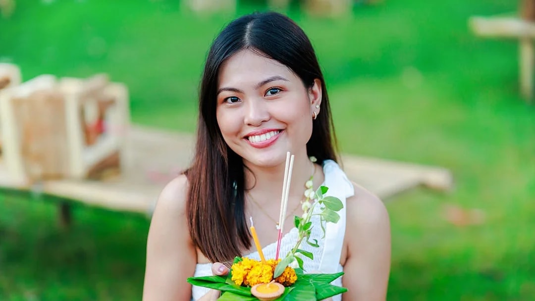 Woman holding a krathong at Chiang Mai Sky Lanterns Festival.