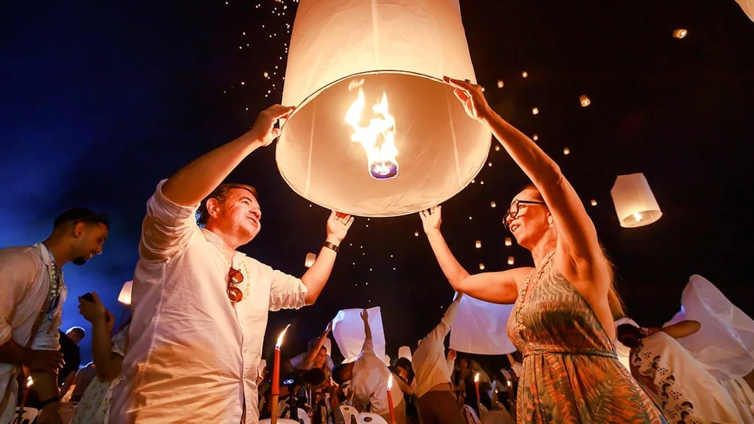 Releasing a sky lantern at Chiang Mai Sky Lanterns Festival, Thailand.