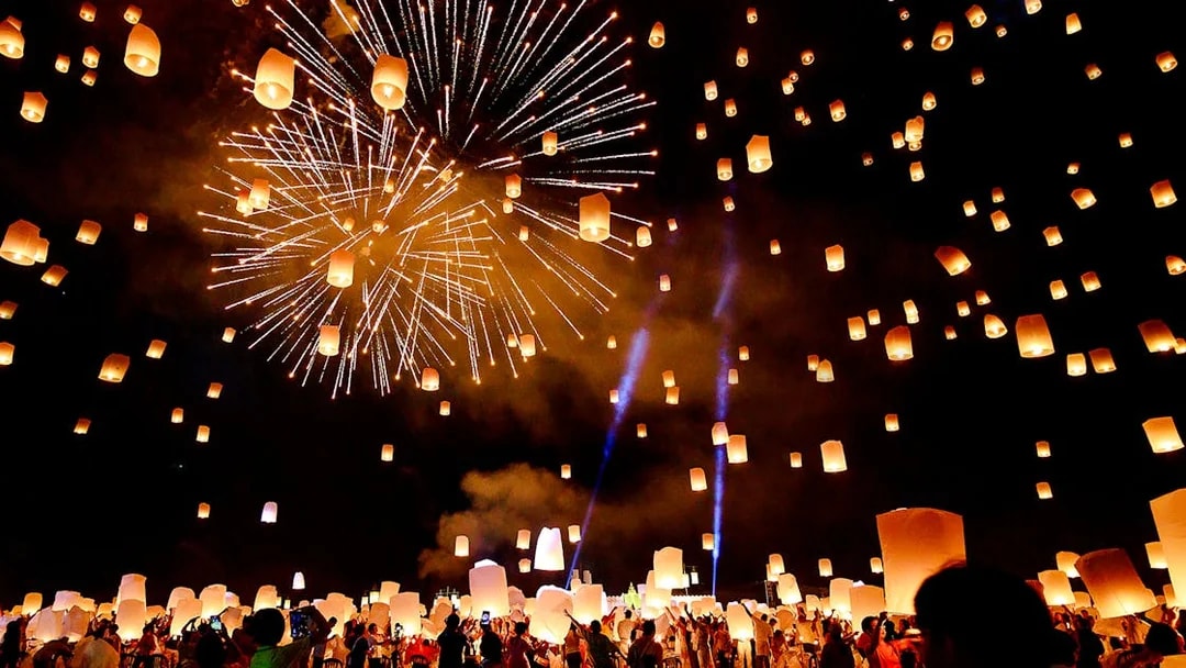 Sky lanterns and fireworks illuminate the night at Chiang Mai Sky Lanterns Festival.