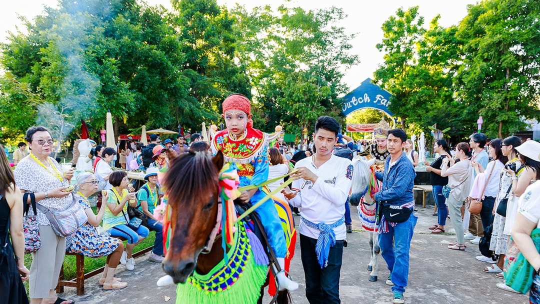 Young boy in traditional attire on a decorated horse at Chiang Mai Sky Lanterns Festival parade.