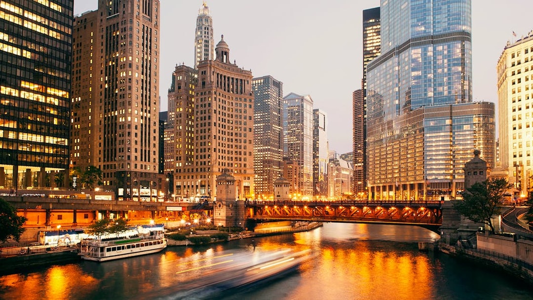 DuSable Bridge illuminated at twilight with Chicago skyline in the background.