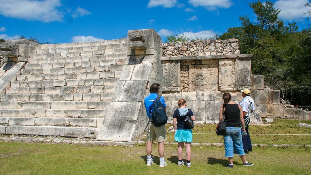 Tourists exploring the ancient ruins at Chichen Itza, Mexico.