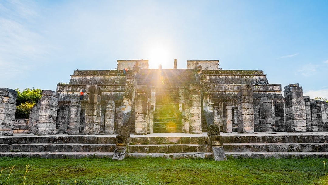 Chichén Itzá temple with sunrise in the background during a guided tour.