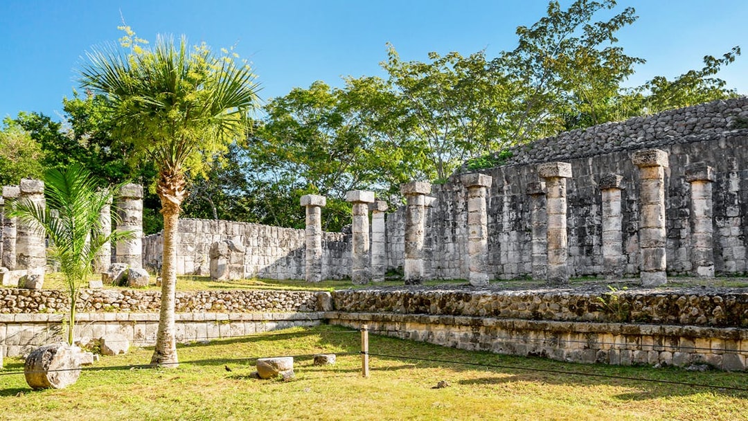 Ancient stone columns at Chichén Itzá during sunrise tour, Yucatán, Mexico.