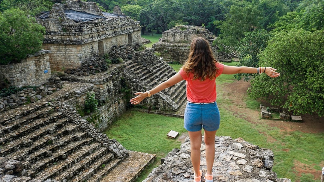 Woman overlooking ancient Mayan ruins in Yaxchilan, Mexico.