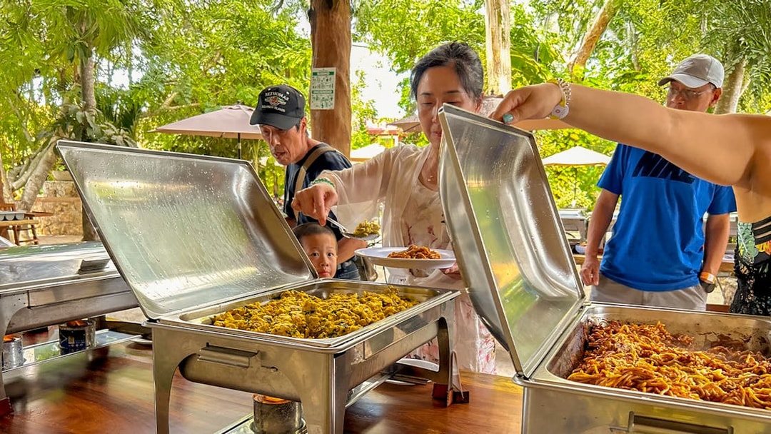 Tourists serving themselves at a buffet lunch during Chichen Itza tour.