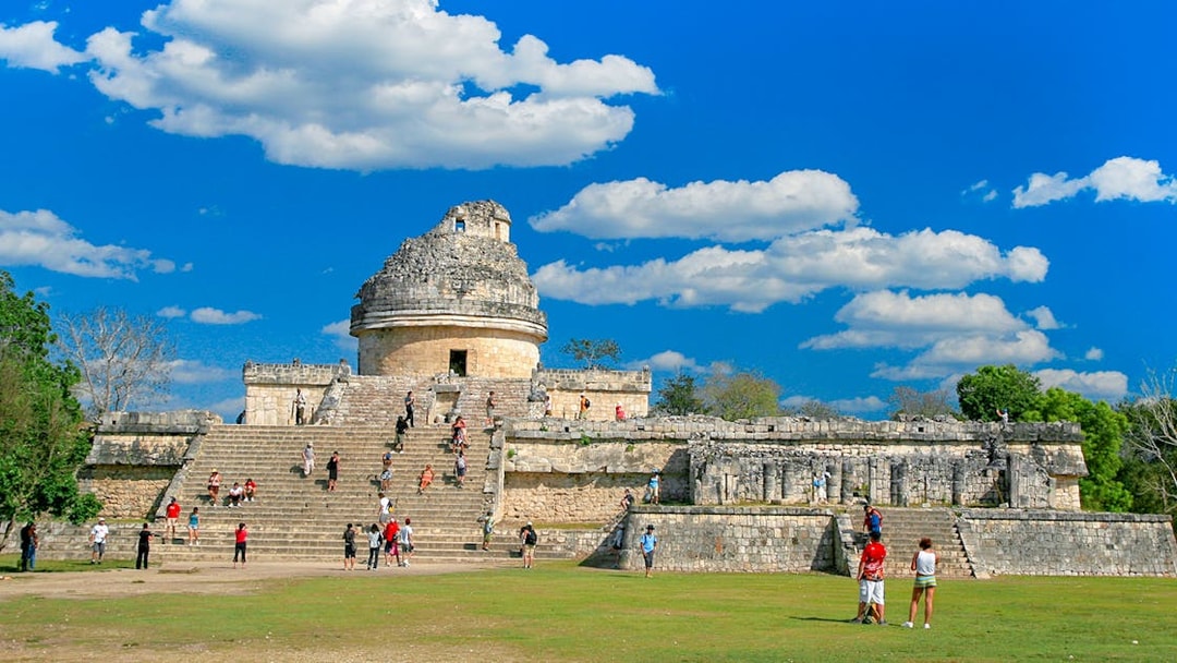 Visitors exploring El Caracol observatory at Chichen Itza, Mexico.