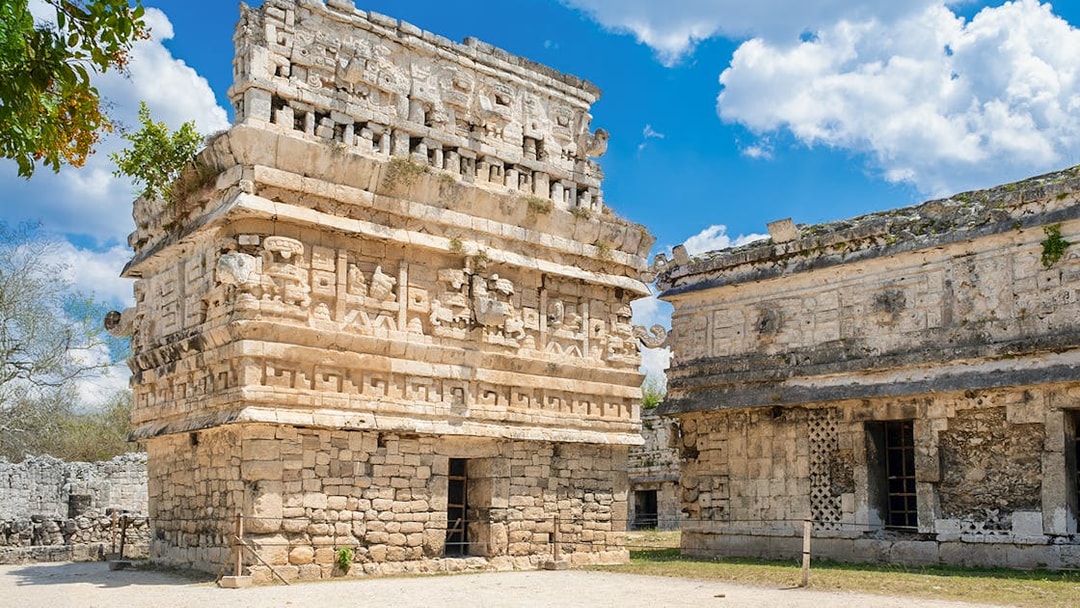 Temple with intricate carvings at Chichen Itza, Mexico, showcasing Mayan architecture.