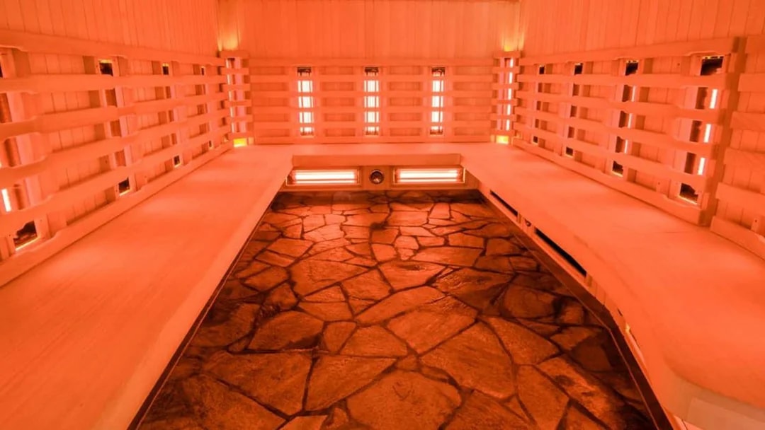 Chocholow Thermal Baths’ Saunarium interior with stone floor and wooden benches.