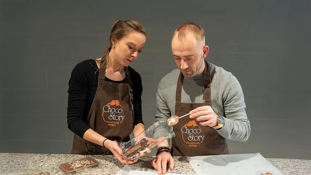 Couple crafting chocolate at Choco-Story Museum workshop.
