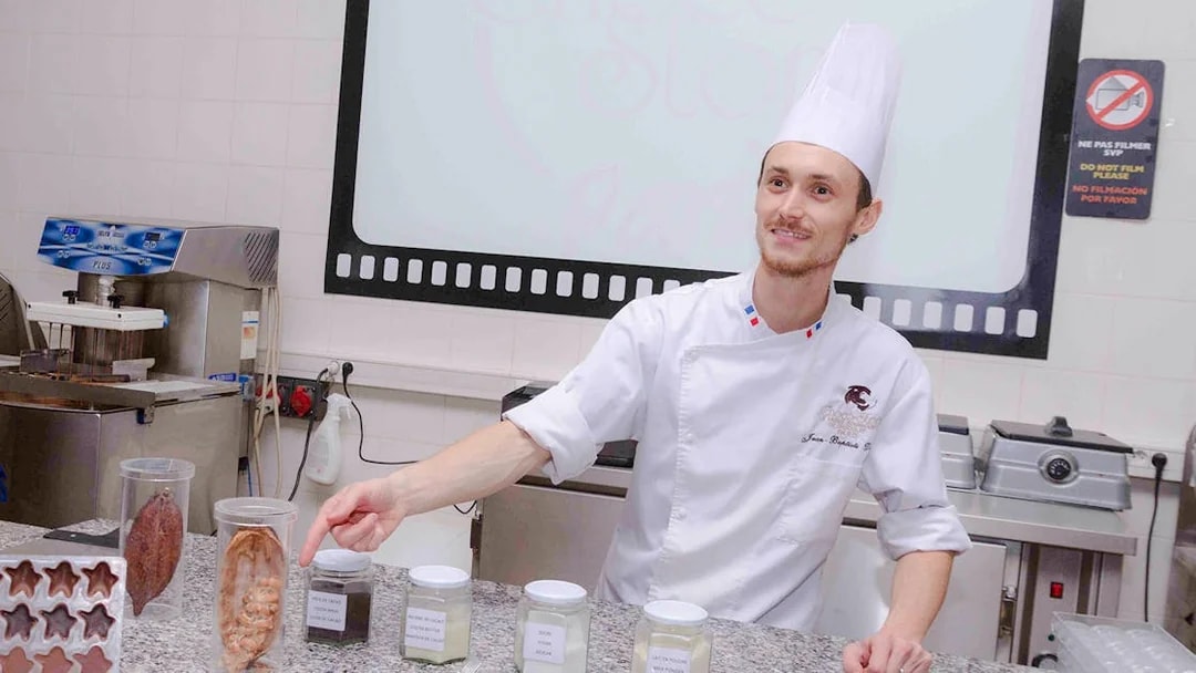 Chocolate chef demonstrating ingredients at Choco-Story Paris.