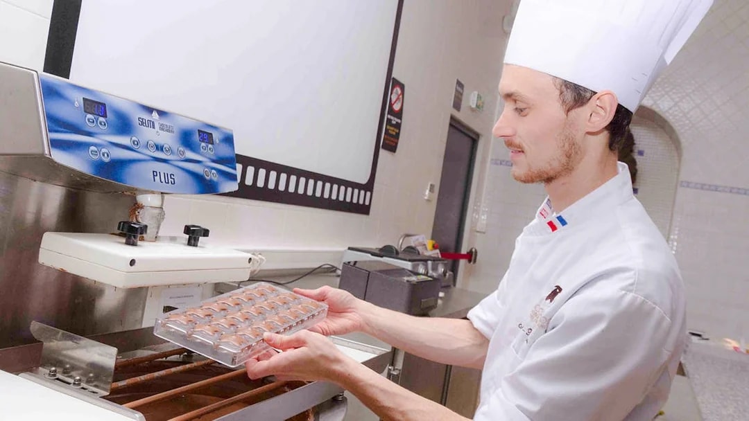 Chocolate chef preparing molds at Choco-Story Paris.