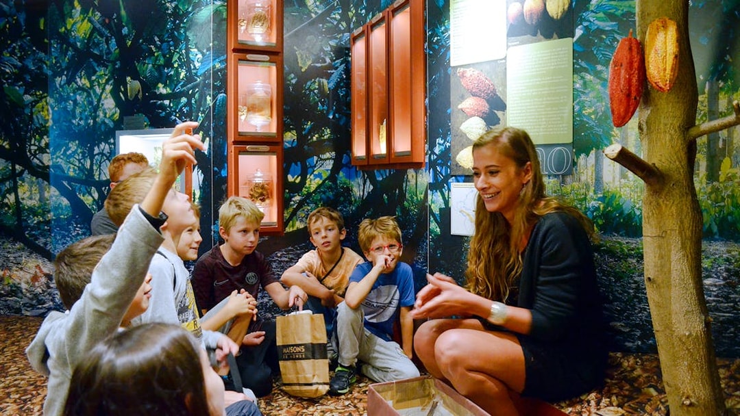 Children learning about cocoa at Choco-Story Paris museum.