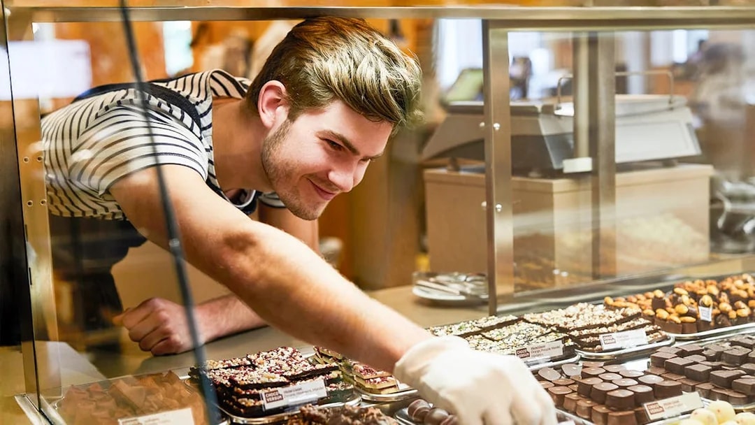 Staff selecting chocolates for guests at Chocoversum, Hamburg.