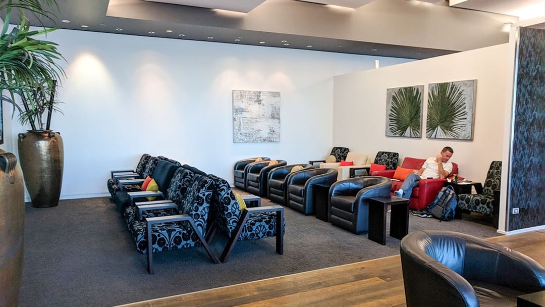 Plaza Premium Lounge seating area with armchairs and modern decor.
