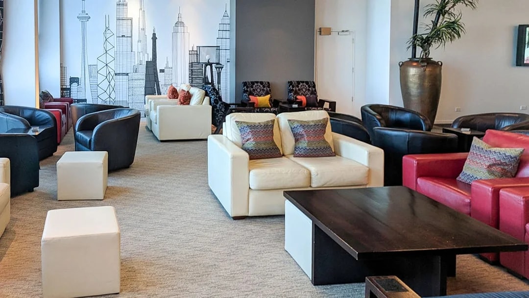 Plaza Premium Lounge seating area with modern decor and city skyline mural.