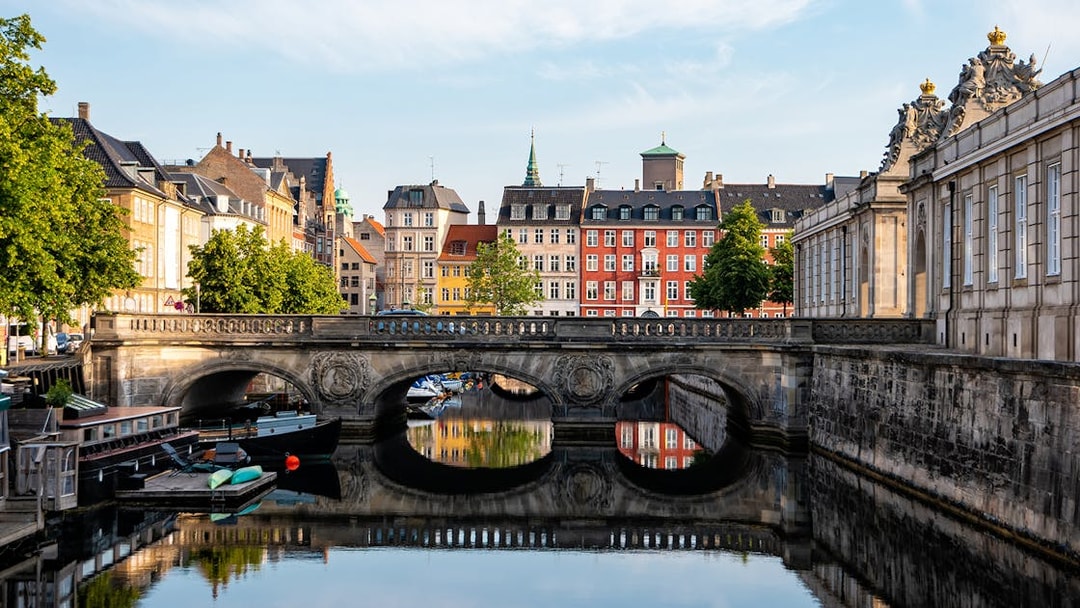 Marmorbroen bridge over canal with colorful buildings in Copenhagen, Denmark.