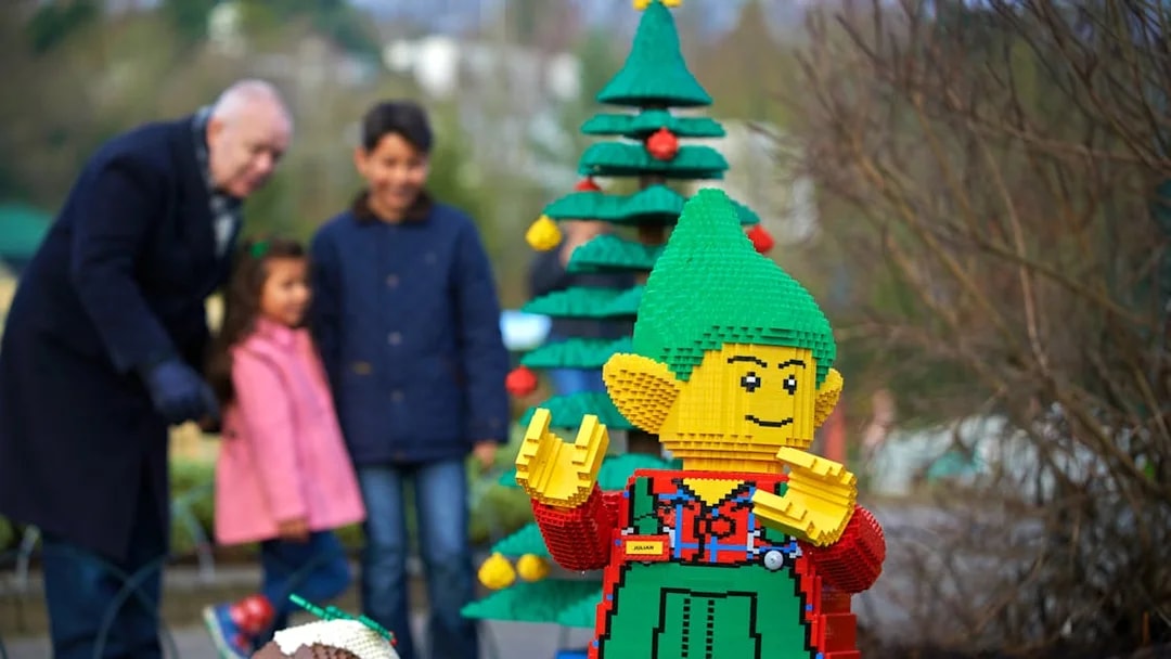 Lego elf sculpture with Christmas tree at Legoland London during holiday season.