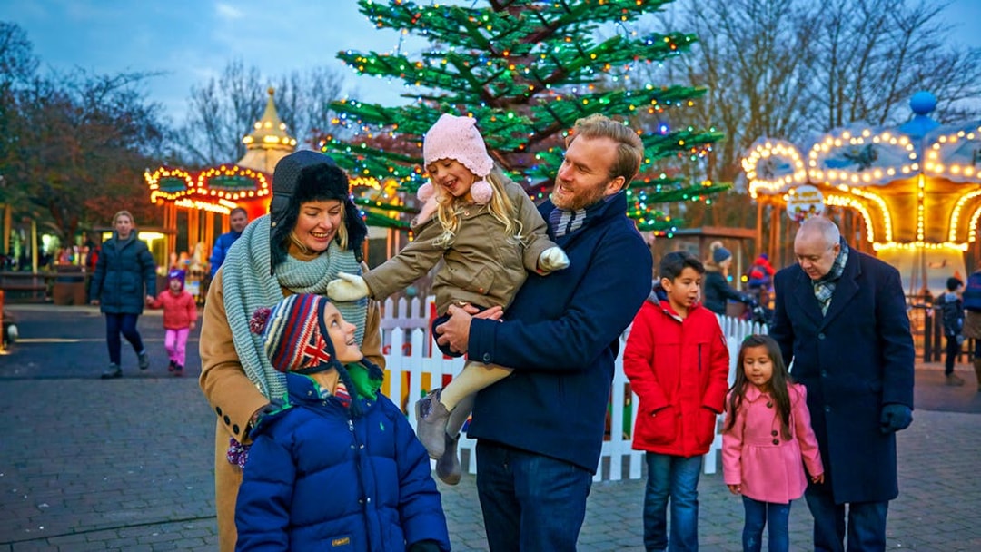 Family enjoying Christmas at Legoland London with festive lights and decorations.