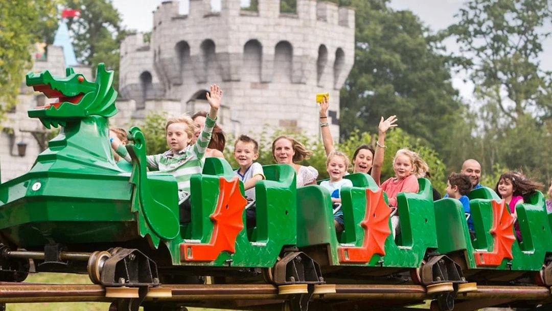 Visitors enjoying a dragon-themed roller coaster at LEGOLAND Windsor Resort.