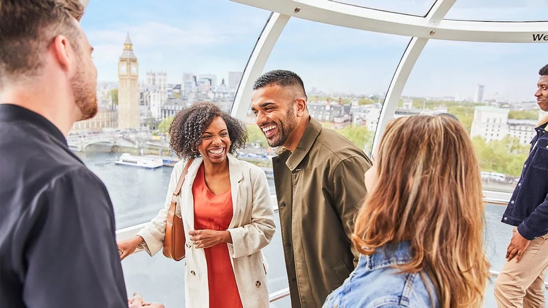 Group enjoying view inside the London Eye with Big Ben in the background.