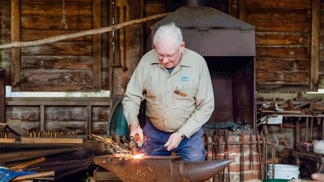 Blacksmith working at an anvil in Churchill Island, Phillip Island Nature Parks.